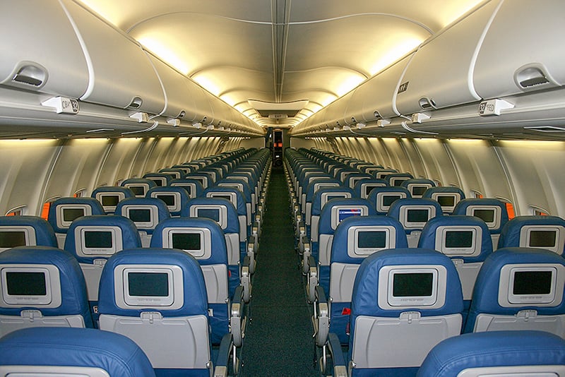 Choosing your seats wisely is one of the best travel hacks for flying. This is an airplane cabin with 3-3 seat configuration.