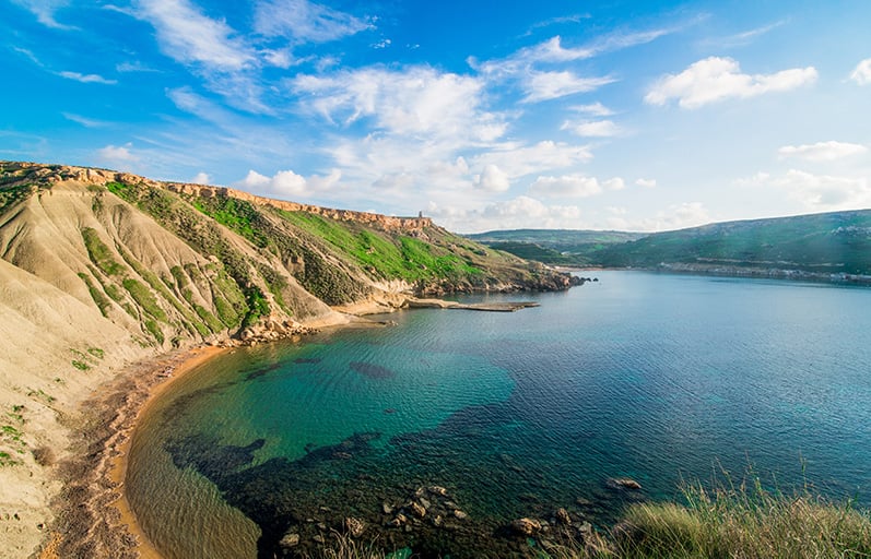 Għajn Tuffieħa is known for its fine red sand, clay slopes, and dramatic sunsets. It's easily one of the most Instagrammable places in all of Malta.