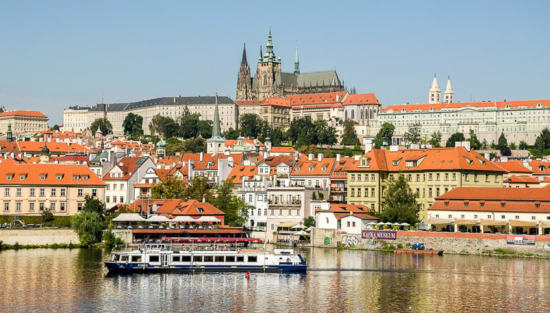 The Prague Castle majestically watches over the Charles Bridge and Vltava River below. 