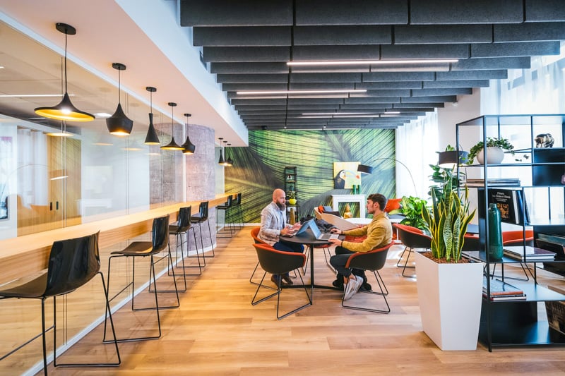 Community living spaces are decked out with modern coworking areas.